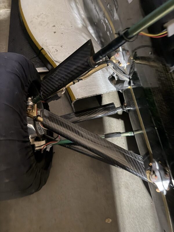 Carbon-fibre wishbone arms and pushrod converging on the wheel under the sidepod.